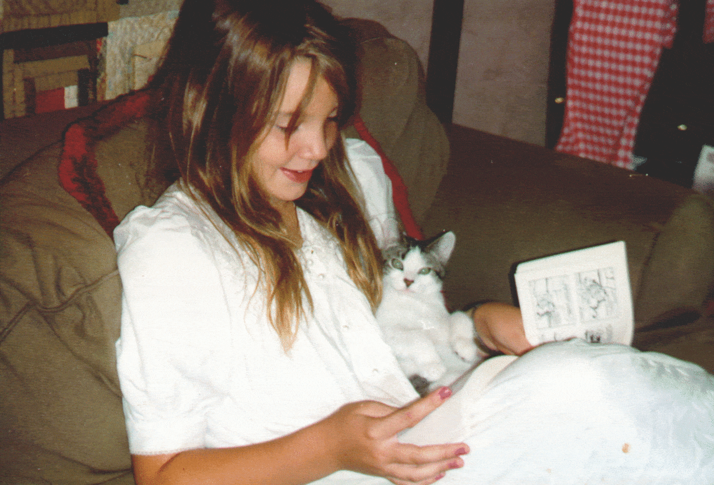 A young Dr. Sanders reading to her best kitty friend, Frisco