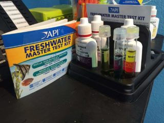 a desk with a box of fresh water and other medical supplies.